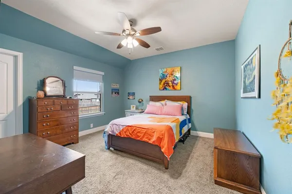 a bedroom with a bed and dresser