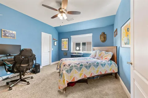 a bedroom with a bed a chair and a chandelier