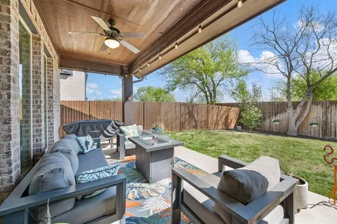 a view of a patio with couches chairs and a backyard