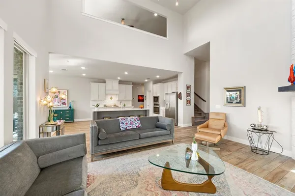 a living room with furniture and a dining table