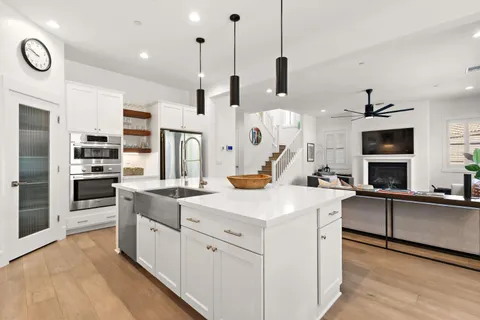 a kitchen with white cabinets and stainless steel appliances