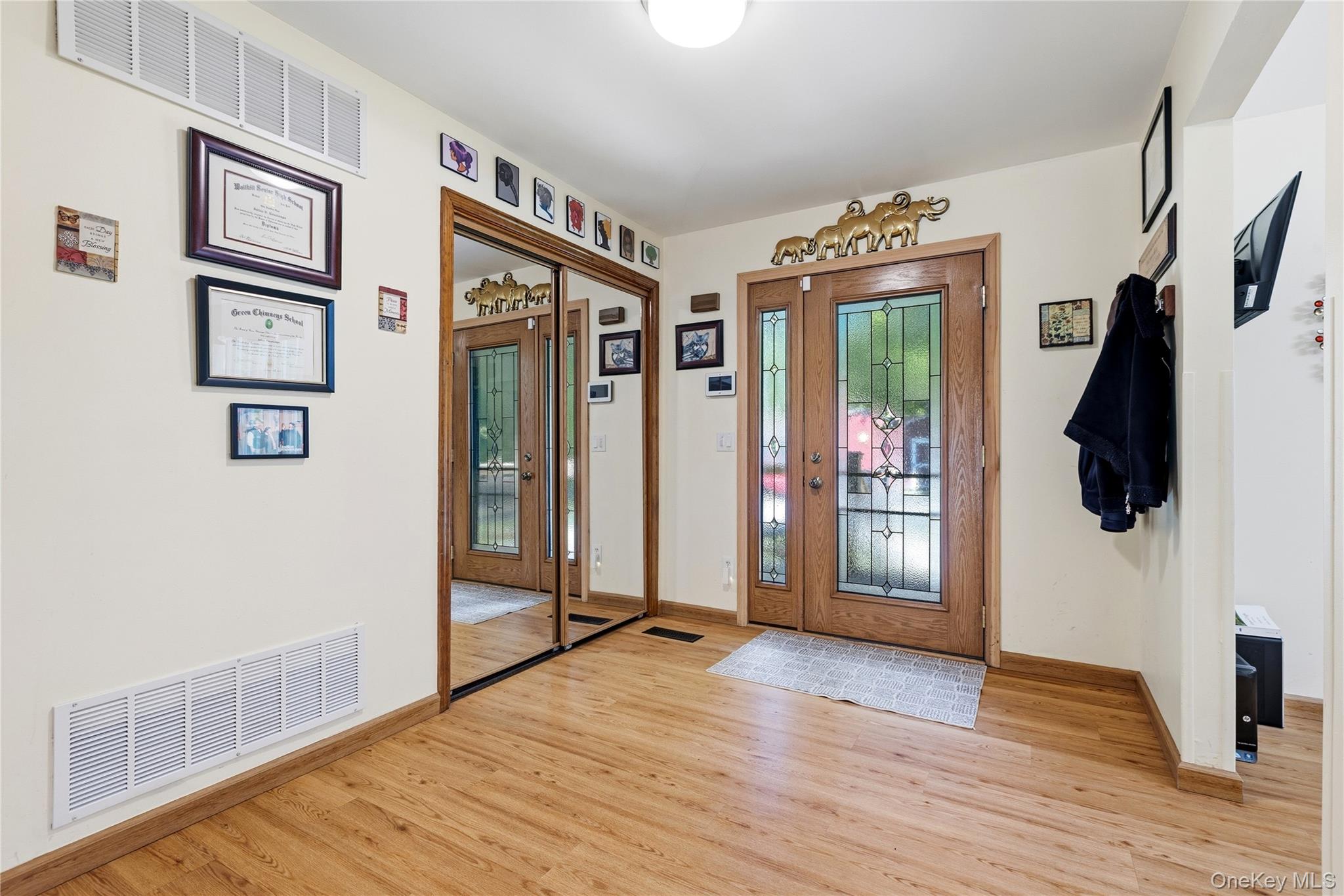 239-241 Fosler Road Highland, NY 12528 - Photo 14 of 42 Entryway featuring wood-finish flooring, a double front door with decorative glass inserts, and a full-length mirrored closet