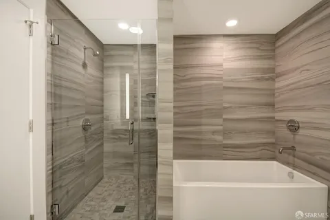 a bathroom with a bathtub and shower