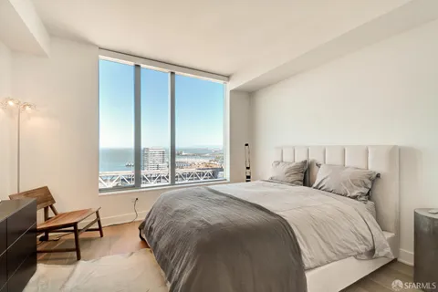 a spacious bedroom with a bed and a large window