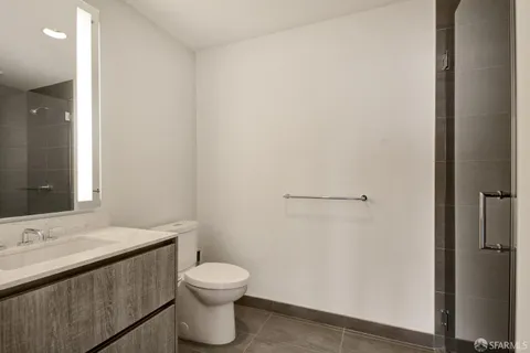 a bathroom with a sink a toilet and a mirror