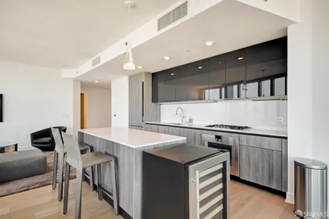 a kitchen with a sink cabinets and wooden floor