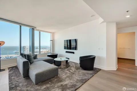 a living room with couches and a flat screen tv