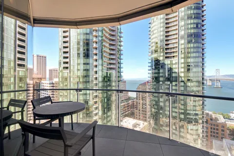 a view of a balcony with chairs and a table