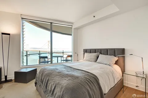 a bedroom with a large bed and a large window