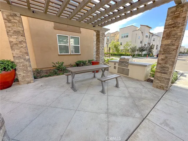 a room with patio furniture and a grill