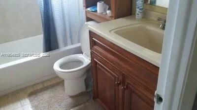 a bathroom with a toilet and a mirror