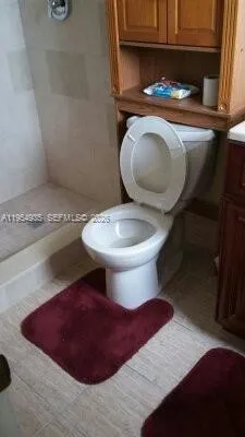 a bathroom with a sink toilet and a mirror