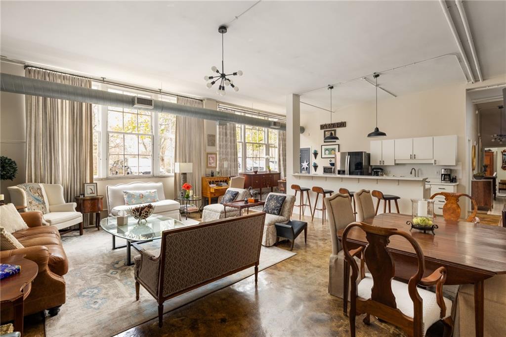 a living room with lots of furniture and a chandelier