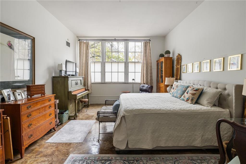 138 Kirkwood Road Northeast, Unit 14 Atlanta, GA 30317 - Photo 16 of 38 a bedroom with a bed and wooden floor