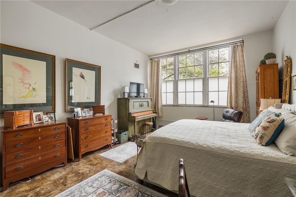 138 Kirkwood Road Northeast, Unit 14 Atlanta, GA 30317 - Photo 17 of 38 a bedroom with a bed and wooden floor