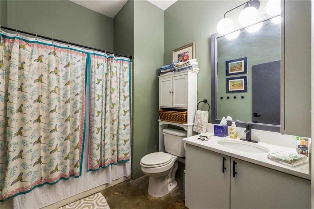 138 Kirkwood Road Northeast, Unit 14 Atlanta, GA 30317 - Photo 20 of 38 a bathroom with a toilet a sink and a large mirror
