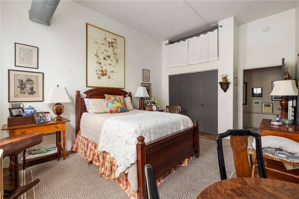 138 Kirkwood Road Northeast, Unit 14 Atlanta, GA 30317 - Photo 22 of 38 a bedroom with a bed and a lamp on the dresser