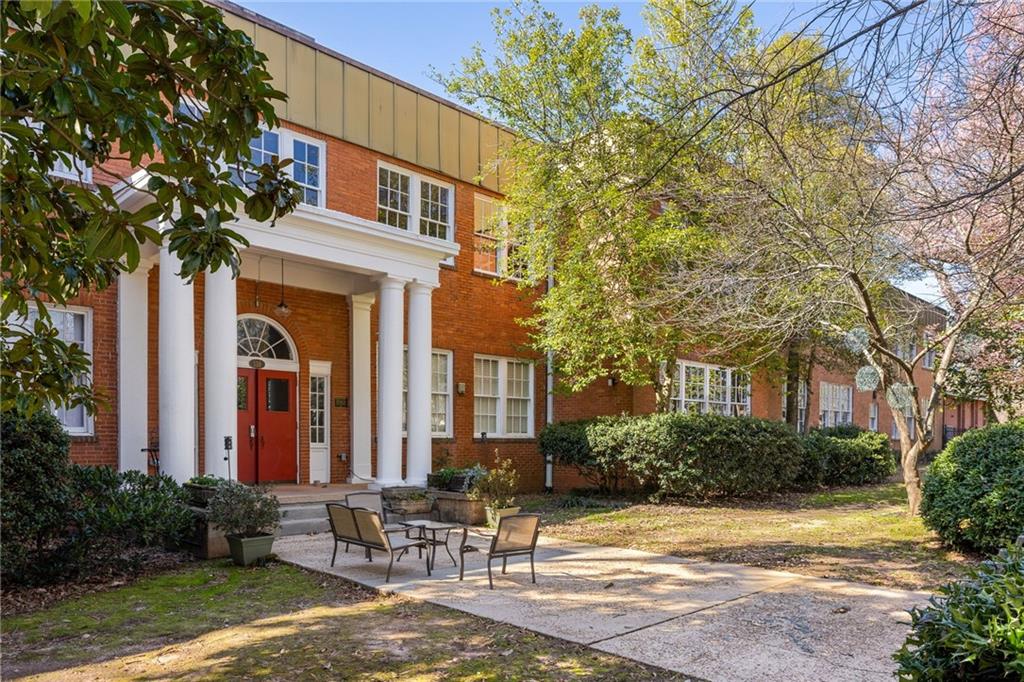 138 Kirkwood Road Northeast, Unit 14 Atlanta, GA 30317 - Photo 29 of 38 a view of a patio with table and chairs and potted plants and large tree