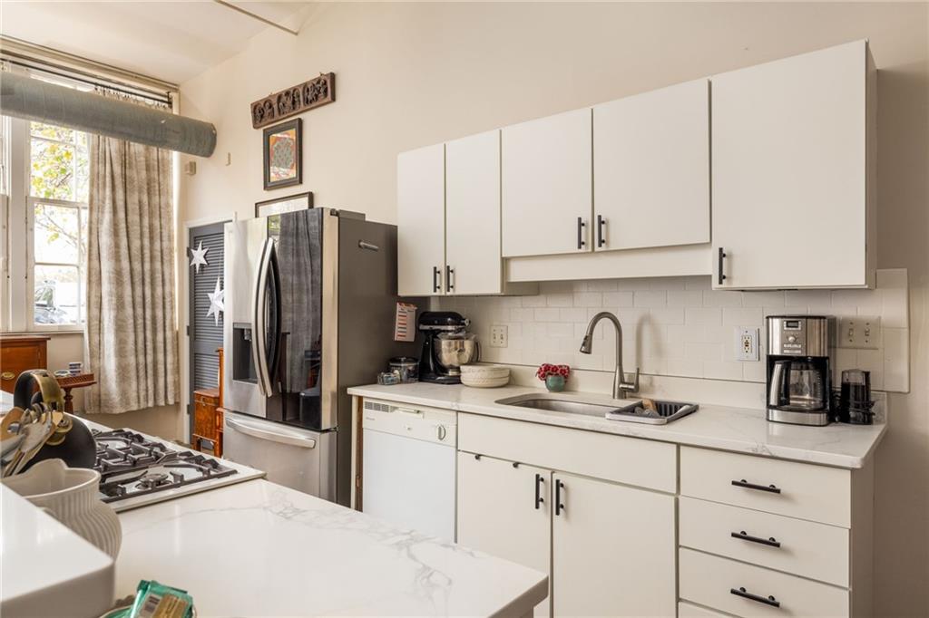 138 Kirkwood Road Northeast, Unit 14 Atlanta, GA 30317 - Photo 10 of 38 a kitchen with stainless steel appliances granite countertop a refrigerator sink and white cabinets