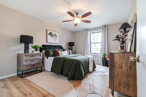 a bedroom with a bed and wooden floor