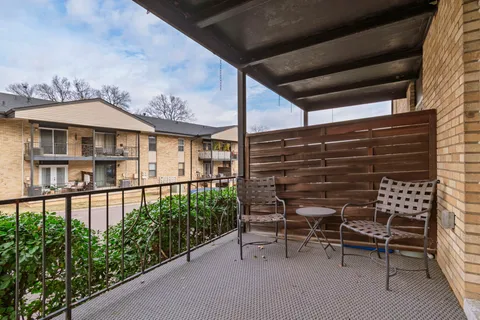 a view of a chairs and table in the balcony
