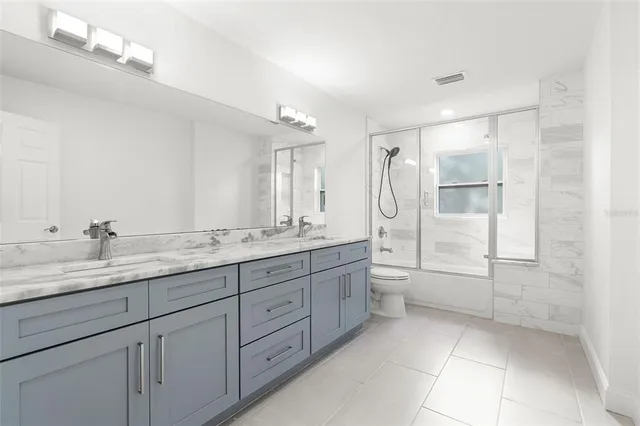 a bathroom with a glass shower door