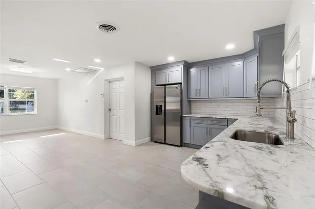 a spacious bathroom with a granite countertop sink mirror and shower