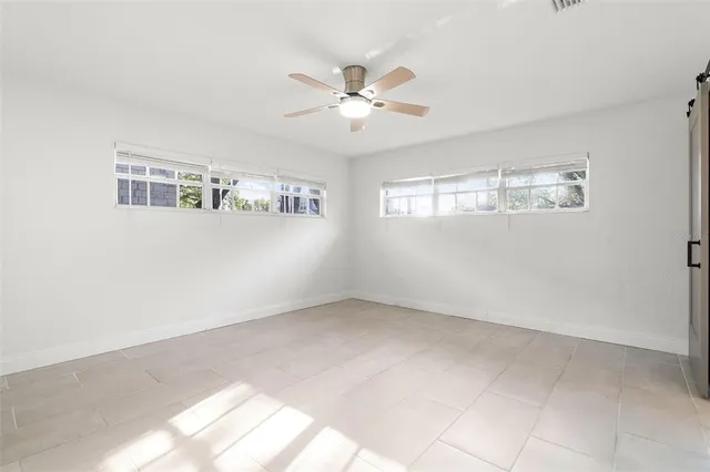 a bathroom with a granite countertop toilet sink and mirror