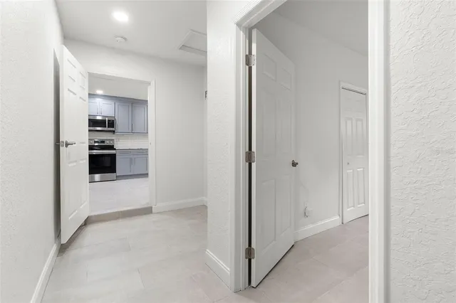 an empty room with a ceiling fan and window