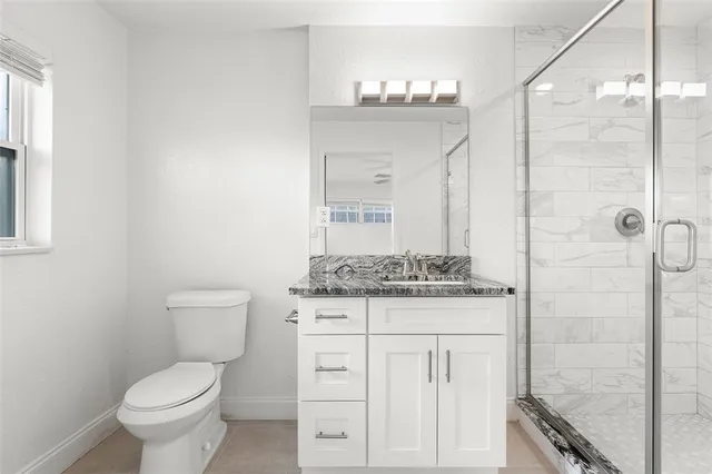 a spacious bedroom with a bed a couch and a window