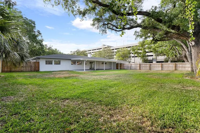 a view of a backyard with swimming pool