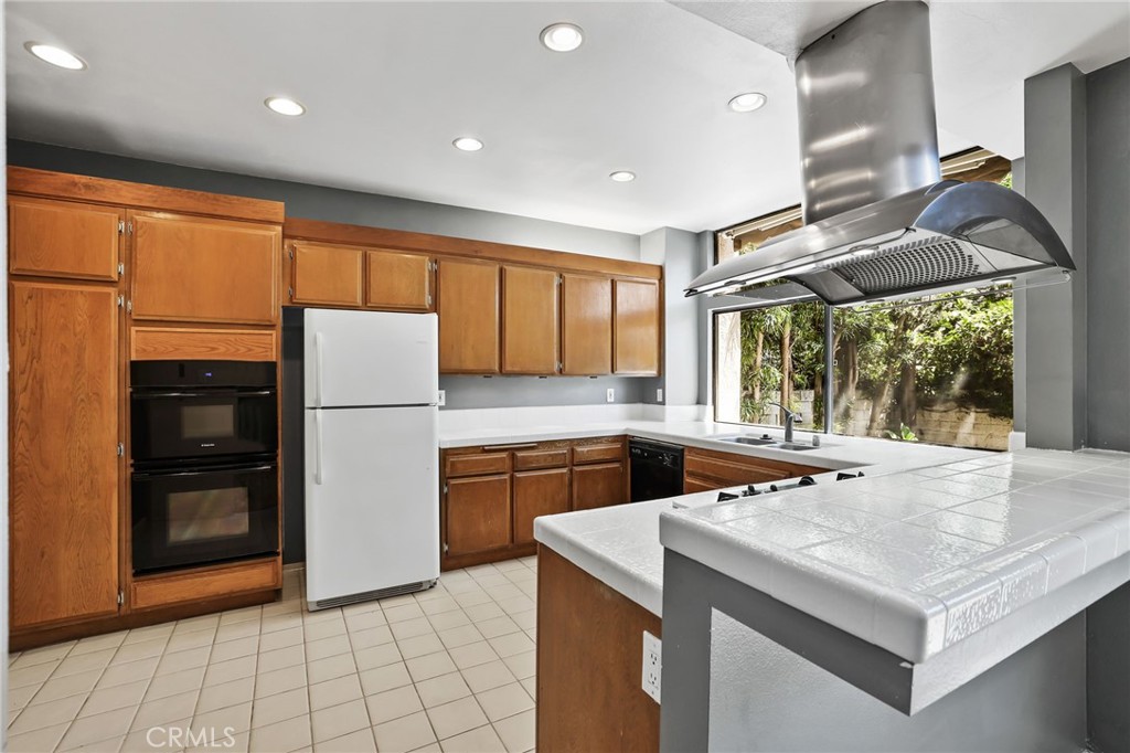 27 Tahoe Irvine, CA 92612 - Photo 1 of 37 a kitchen with a sink a refrigerator and a stove top oven