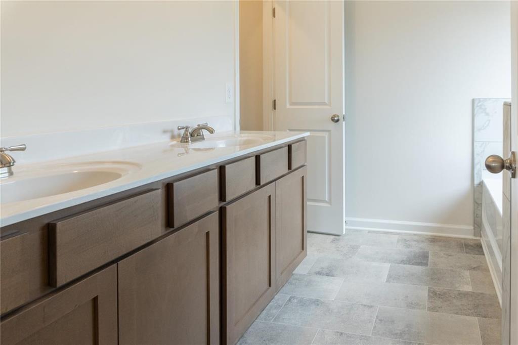 74 Hampton Ridge Way Jefferson, GA 30549 - Photo 11 of 15 a bathroom with a sink and a mirror