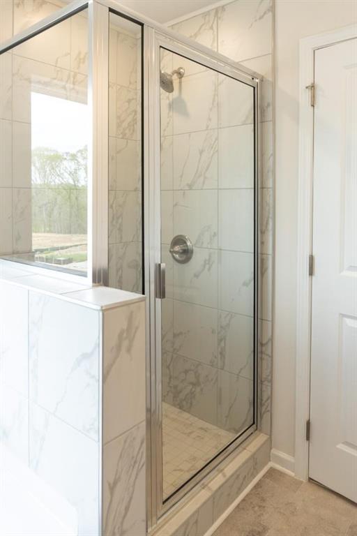 74 Hampton Ridge Way Jefferson, GA 30549 - Photo 12 of 15 a bathroom with a glass shower door