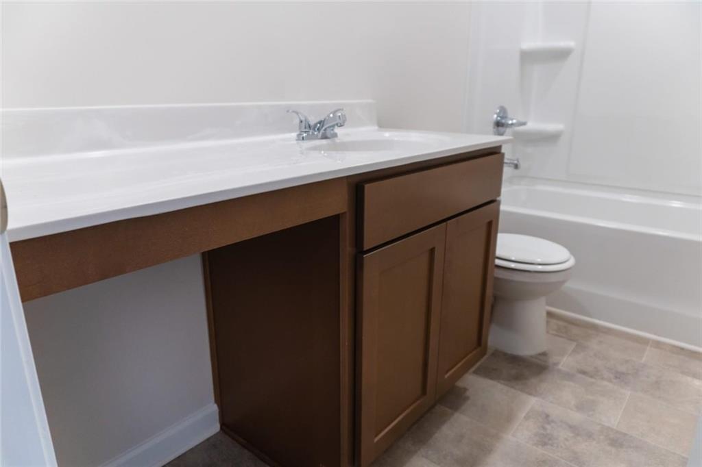 74 Hampton Ridge Way Jefferson, GA 30549 - Photo 5 of 15 a bathroom with a sink a toilet and shower