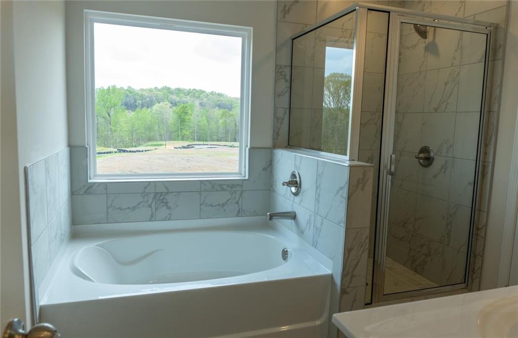 74 Hampton Ridge Way Jefferson, GA 30549 - Photo 10 of 15 a bathroom with a bathtub and shower