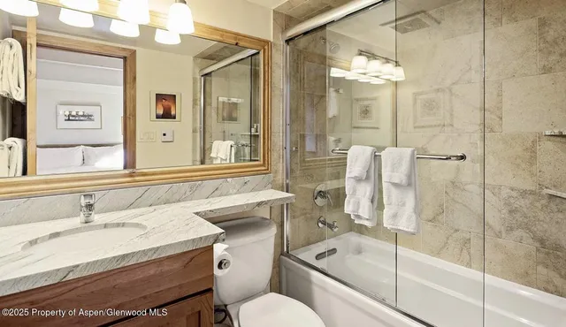 a bathroom with a sink toilet tub and shower