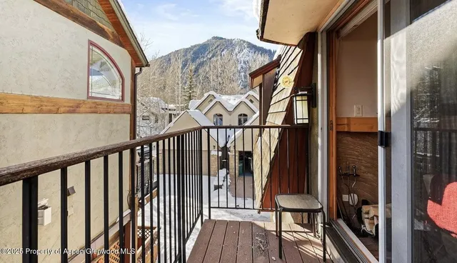 a view of a balcony with wooden floor and furniture