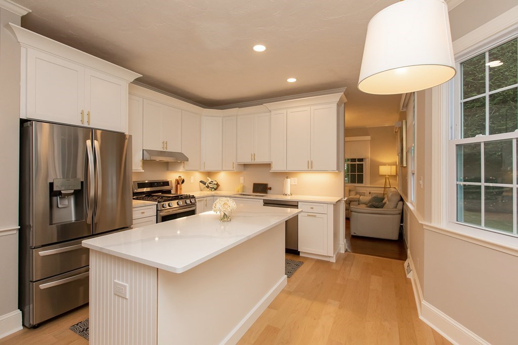 1193 Main Street, Unit A2 Hingham, MA 02043 - Photo 13 of 27 a kitchen with a sink a counter top space stainless steel appliances and cabinets