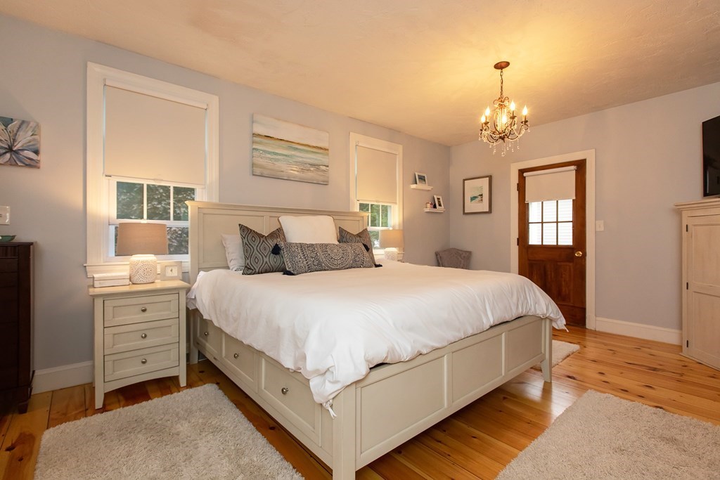 1193 Main Street, Unit A2 Hingham, MA 02043 - Photo 19 of 27 a spacious bedroom with a bed and window