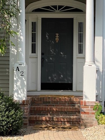 1193 Main Street, Unit A2 Hingham, MA 02043 - Photo 2 of 27 a front view of a house with a yard