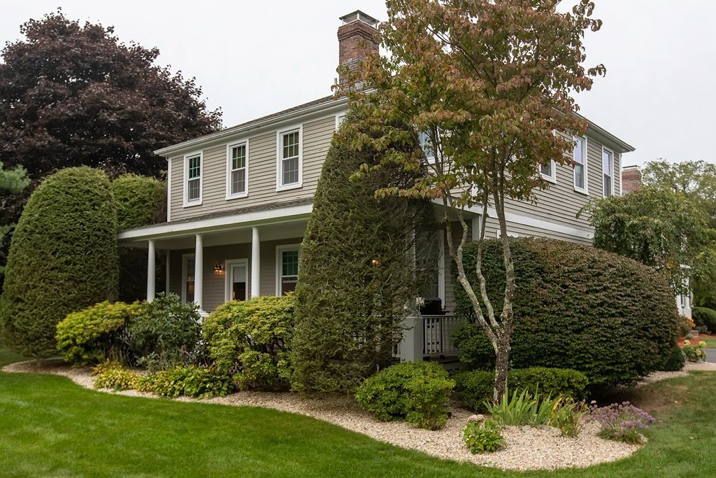 1193 Main Street, Unit A2 Hingham, MA 02043 - Photo 3 of 27 a front view of a house with a garden