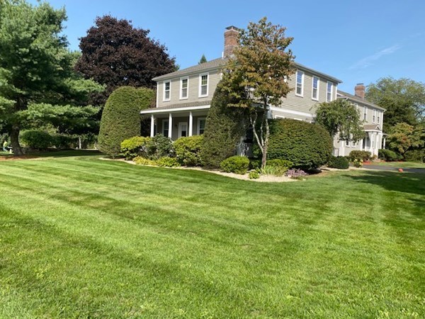 1193 Main Street, Unit A2 Hingham, MA 02043 - Photo 4 of 27 a front view of a house with a yard