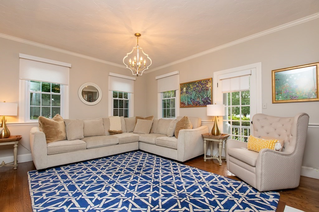 1193 Main Street, Unit A2 Hingham, MA 02043 - Photo 8 of 27 a living room with furniture and a chandelier