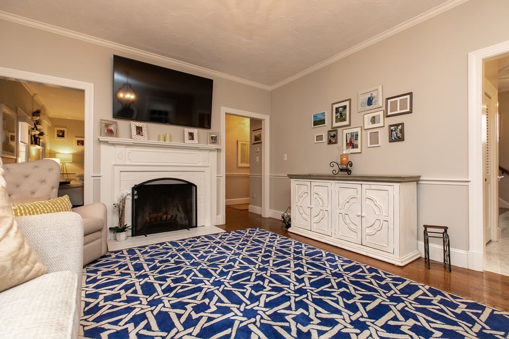 1193 Main Street, Unit A2 Hingham, MA 02043 - Photo 9 of 27 a living room with furniture a flat screen tv and a fireplace