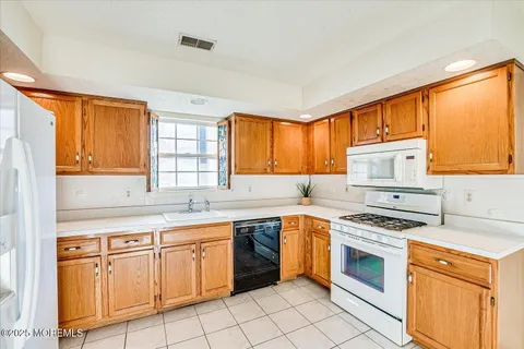 a kitchen with stainless steel appliances granite countertop a stove sink and cabinets