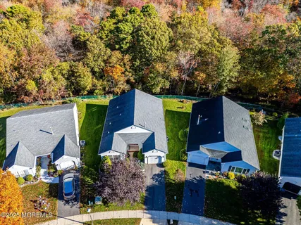 a view of pool with lawn chairs under an umbrella
