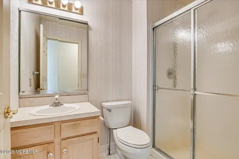 a bathroom with a toilet a sink and a mirror