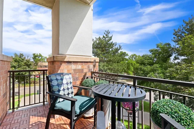 a view of a chairs and table in the balcony