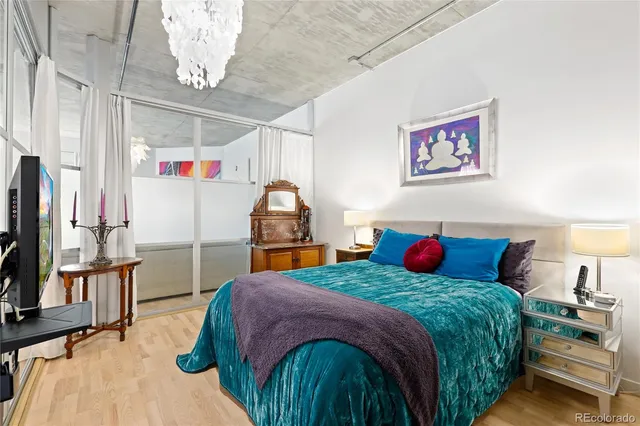 a bedroom with a bed and a chandelier